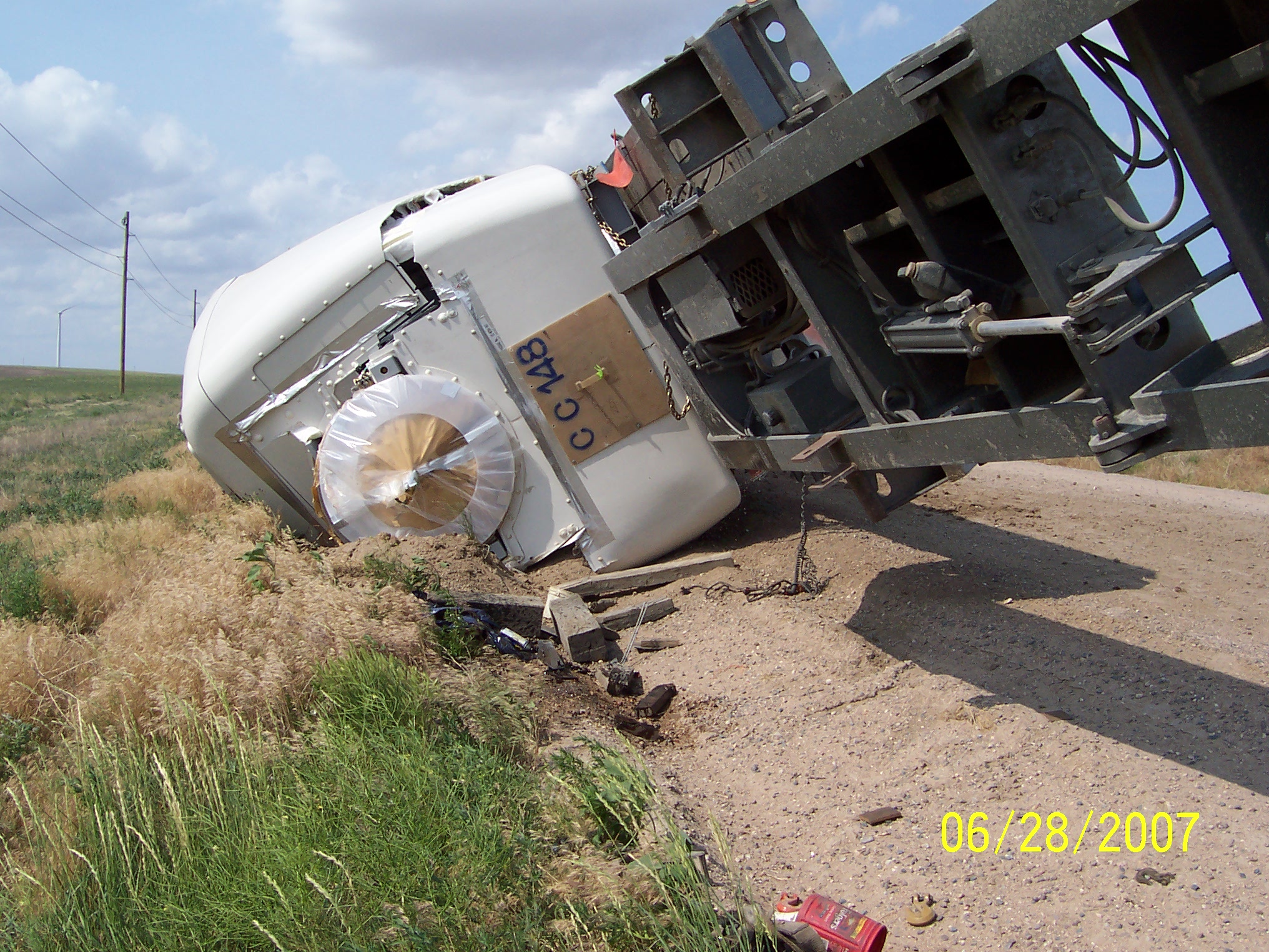 Photo of Windmill Nacelle overturned and heavily damaged on the rear of a truck, near Grover Colorado